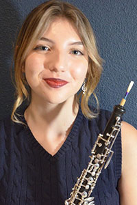 Catalina Huss 
  posing with her oboe