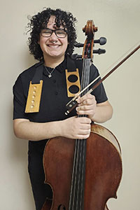 JJ posing with their cello