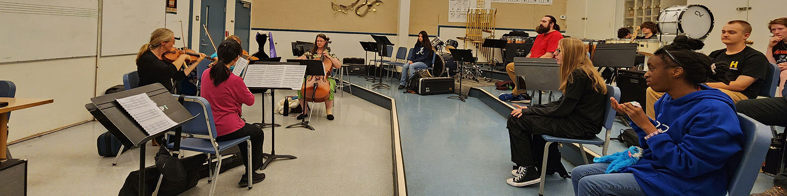musicians playing for a classroom of kids