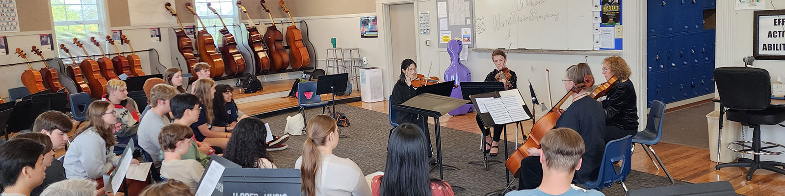 musicians playing for a classroom of kids